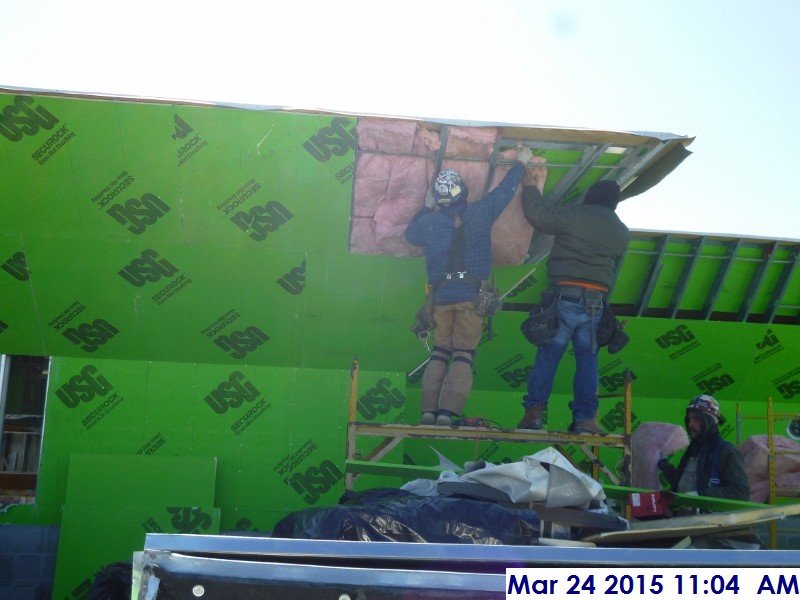 Installing insulation along the parapet Facing South
